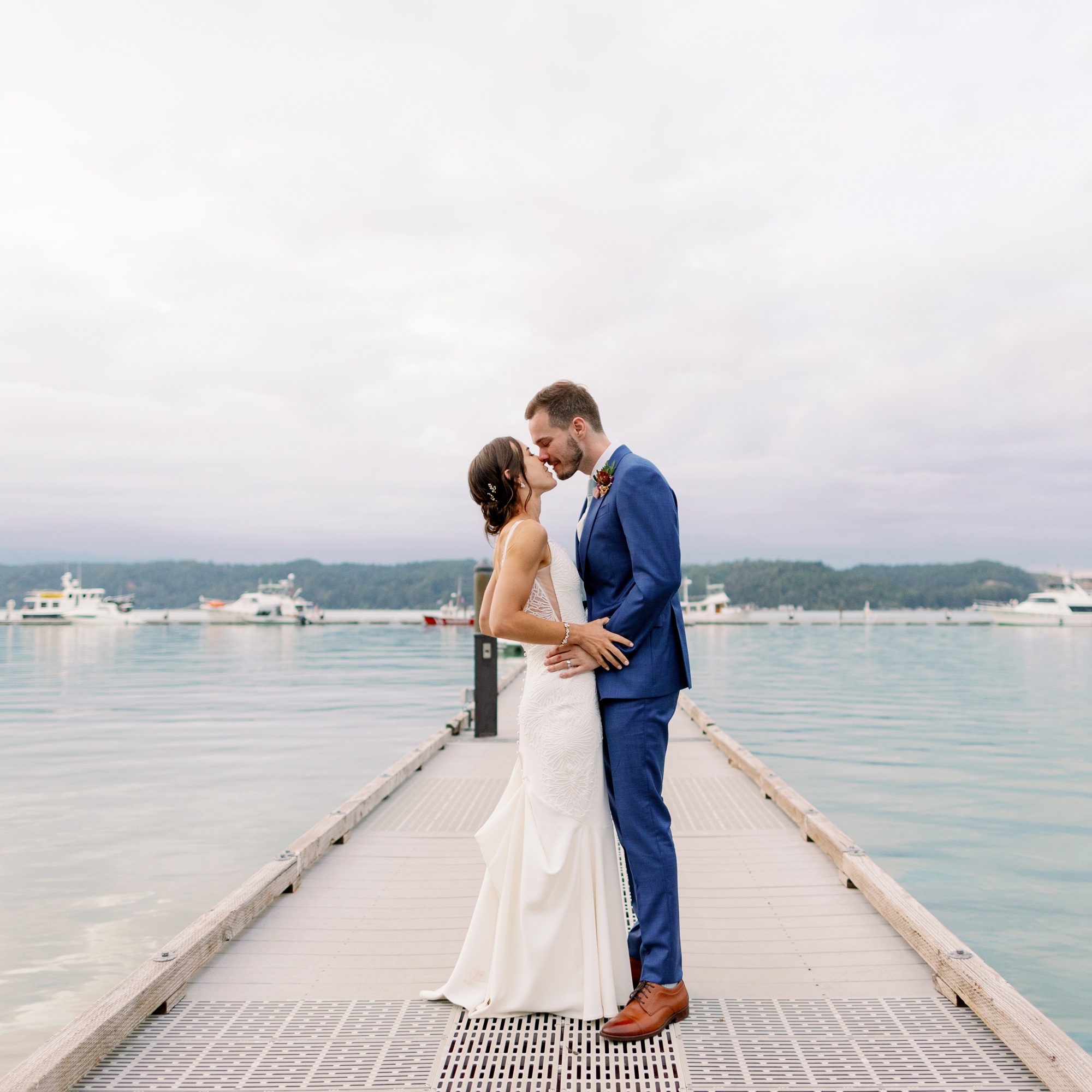 Wedding couple kissing on dock at Alderbrook Resort