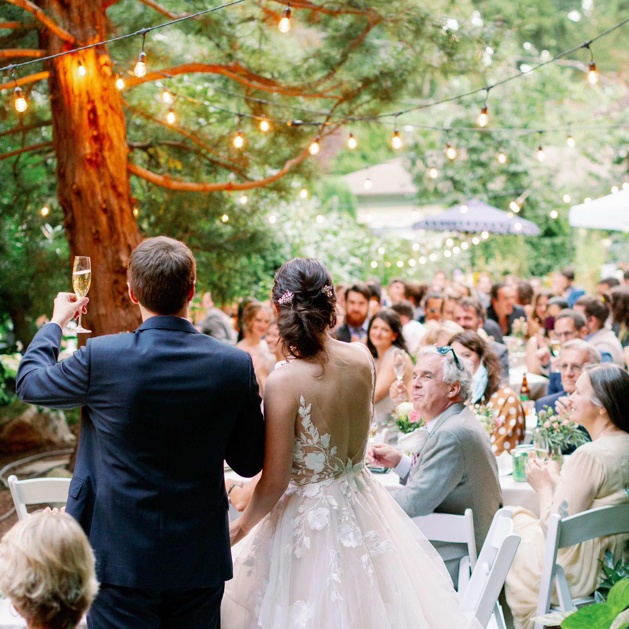 Couple toasts at backyard wedding in Seattle